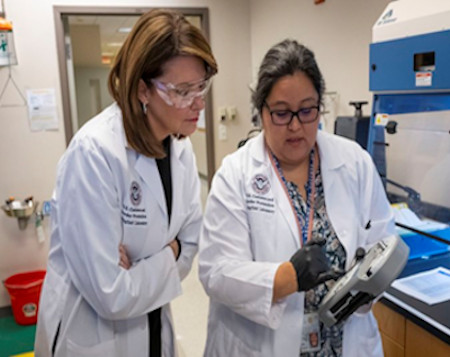 Women working in an evidence lab 450x357 Women working in an evidence lab