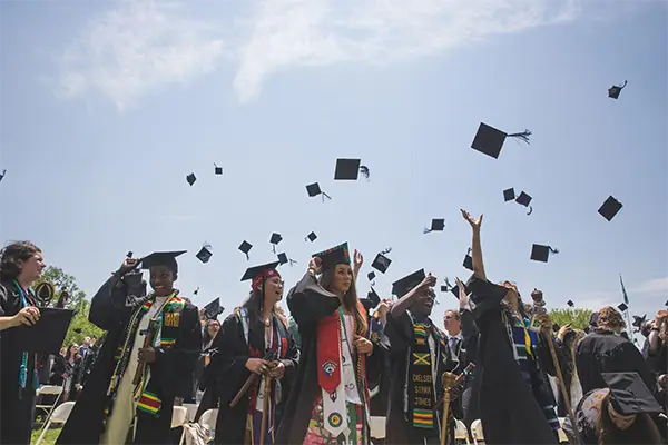 Graduate tossing their hats at graduation