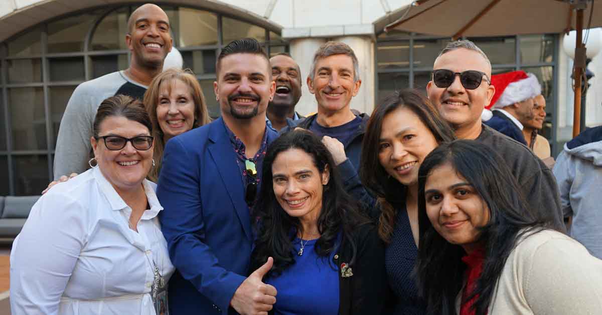 diverse employees posing for a group photo outdoors2 diverse employees posing for a group photo outdoors