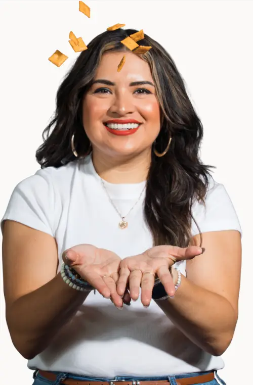 woman smiling tossing up cheez-its