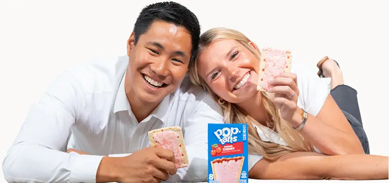 Man and woman holding up poptarts smiling