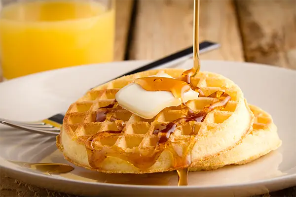 Eggo waffles with pouring syrup