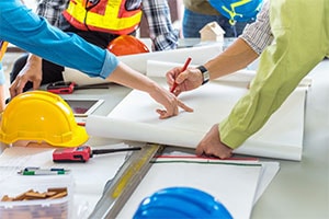 People working around architectural plans