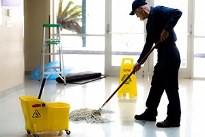 Janitor cleaning floor with mop