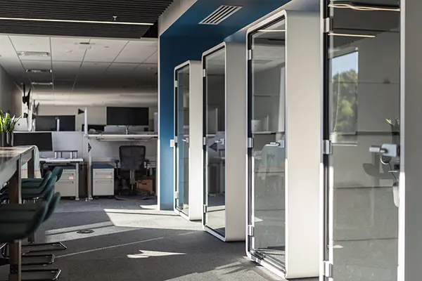 inner office space with high and low desks and glass door offices